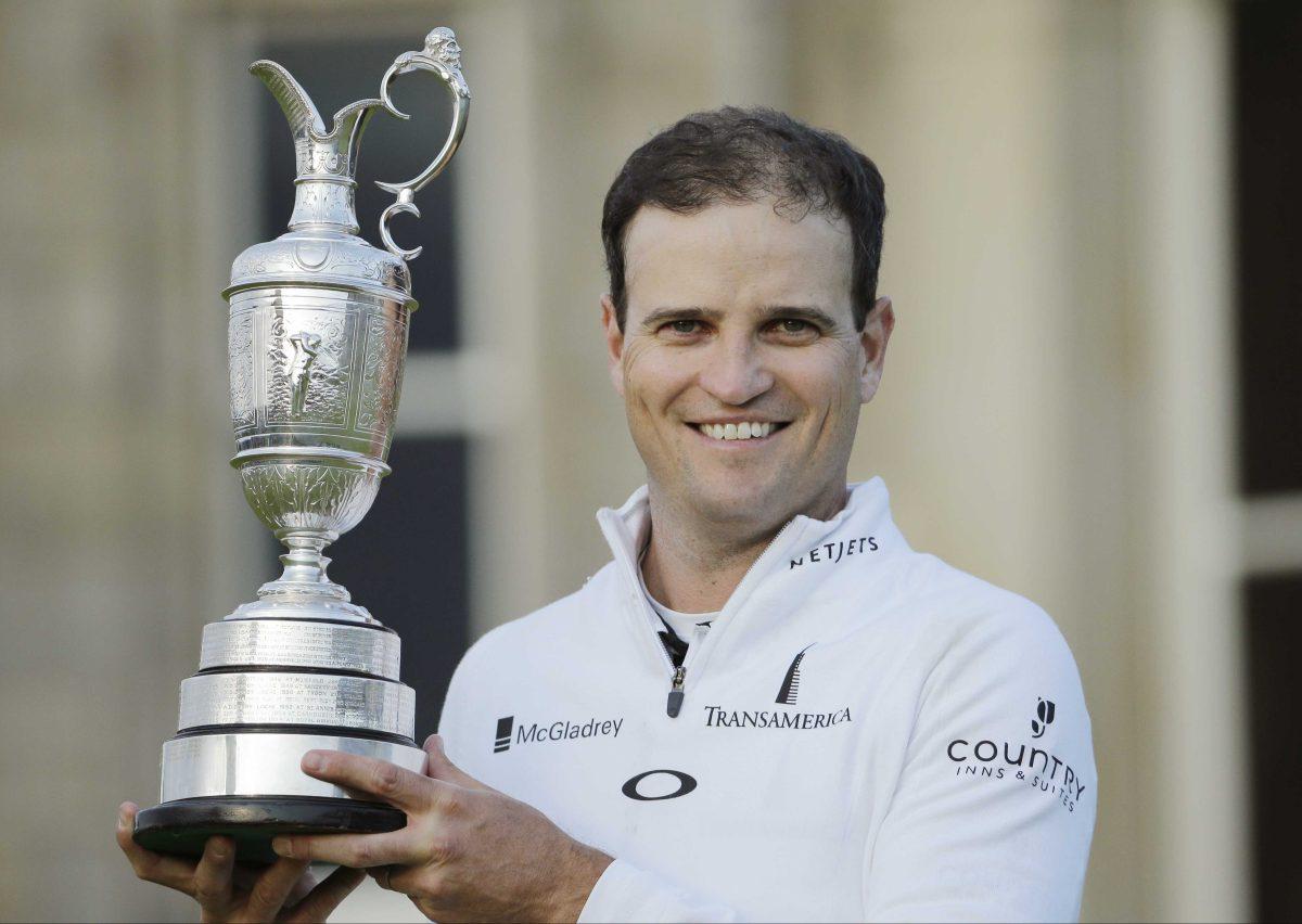 United States&#8217; Zach Johnson poses with the trophy after winning a playoff after the final round at the British Open Golf Championship at the Old Course, St. Andrews, Scotland, Monday, July 20, 2015. (AP Photo/David J. Phillip)