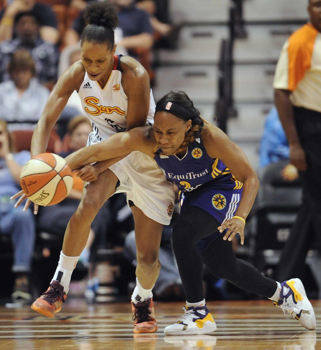 Connecticut Sun&#8217;s Jasmine Thomas, left, and Los Angeles Sparks&#8217; Temeka Johnson, right, chase down a loose ball during the first half of a WNBA basketball game, Friday, June 26, 2015, in Uncasville, Conn. (AP Photo/Jessica Hill)