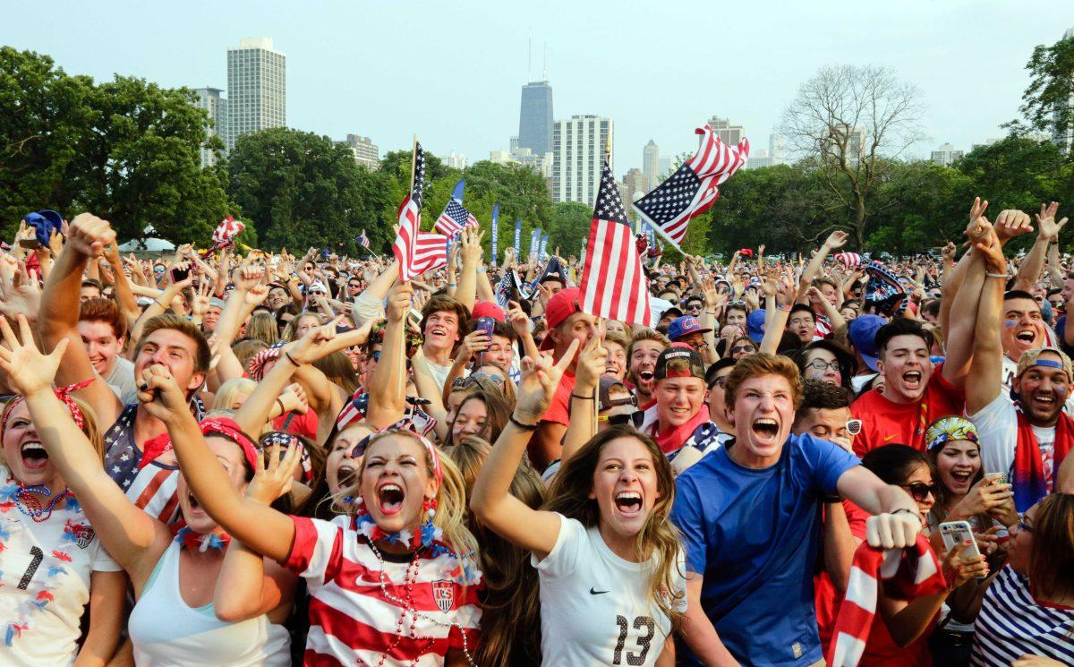 Fans of U.S. Soccer are seen cheering after a goal by Carli Lloyd during the Women's World Cup final Sunday, July 5, 2015. The fans watched the action on a jumbo screen at a watch party in Chicago's Lincoln Park. (AP Photo/Teresa Crawford)