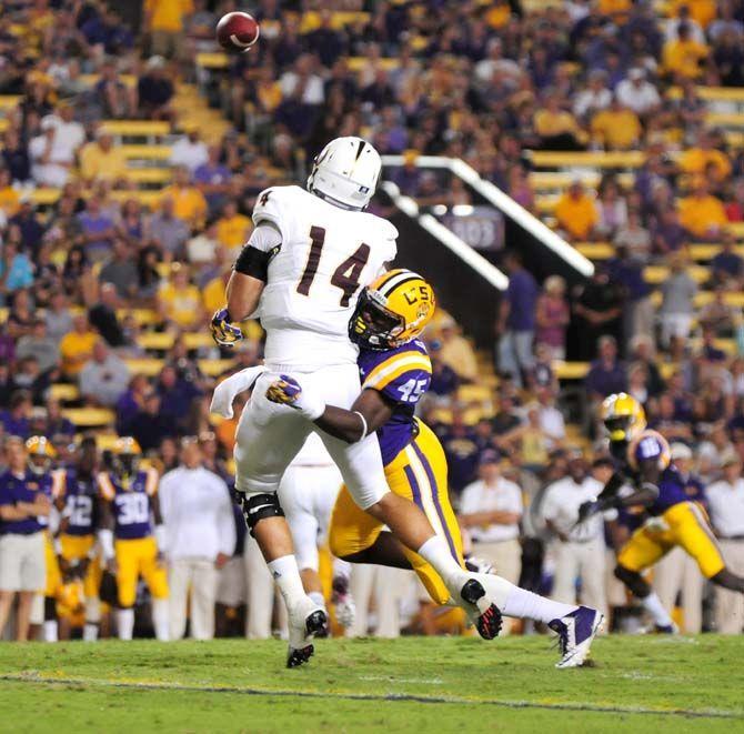 LSU junior linebacker Deion Jones (45) tackles ULM senior quarterback Pete Thomas (14) Saturday, Sep. 13, 2014 during the Tigers' 31-0 victory against the Warhawks in Tiger Stadium.