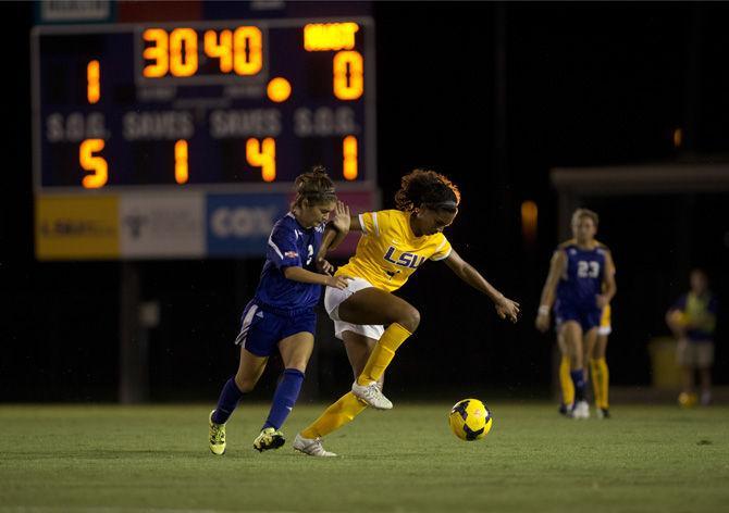 LSU junior forward Summer Clarke (4) maintains control of the ball as Northwestern State sophomore defender Amy Renteria (2) attempts to gain possession on Tuesday, Aug. 25, 2015, during the Tigers' 1-1 tie against the Lady Demons at LSU Soccer Stadium.