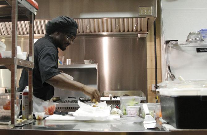 Chef Griouard Weddington prepares a salad to go on Sunday, Aug. 23, 2015 at Simple Joe Cafe located at 3057 Government Street between Time Warp Boutique and Radio Bar.