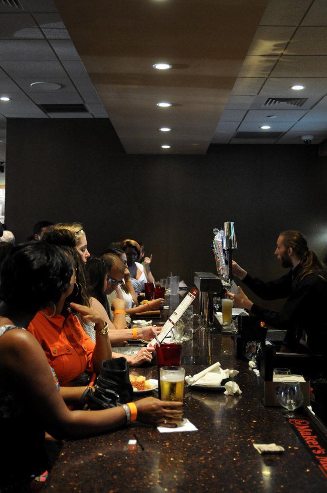 Bartenders serve moviegoers Thursday, Aug. 27, at the grand opening of the Movie Tavern in Citiplace Court.