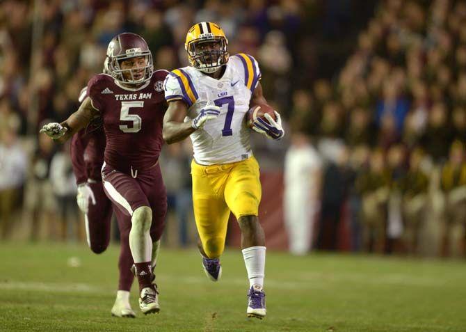 LSU freshman running back Leonard Fournette (7) rushes the ball while senior defensive back Floyd Raven Sr. (5) tries to tackle him during the Tigers' 23-17 victory over Texas A&amp;M on Thursday, Nov.27, 2014 in Kyle field.