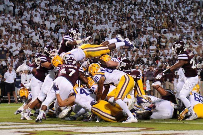 LSU Sophomore Running Back, Leonard Fournette (7), jumps over Mississippi State to score a touchdown during the Tigers 21-19 win over the Bulldogs on Saturday, at Davis Wade Stadium.