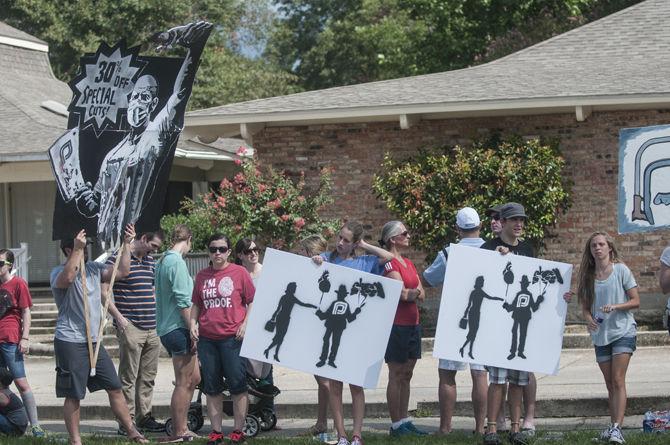 Protesters hold signs outside the planned parenthood health center on Saturday, Aug. 22, 2015 on Government Street.