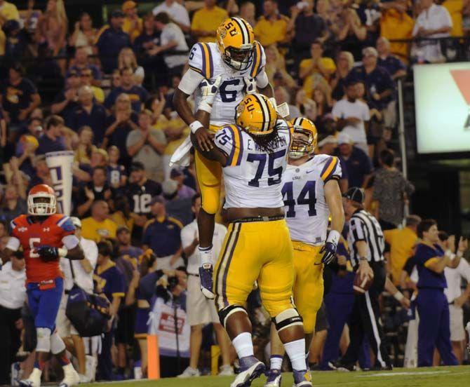 <p>LSU senior offensive tackle Evan Washington (75) lifts fresman quaterback Brandon Harris (6) as sophomore tight end Colin Jeter (44) watches Saturday, September 6, 2014 after the Tigers' 56-0 blow out against Sam Houston State in Tiger Stadium.</p>