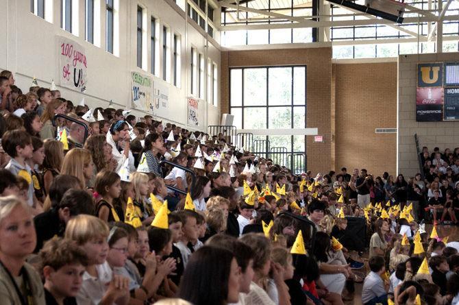 Younger students wear yellow and white hats Friday, Sept. 18, 2015, during the University Laboratory School Centennial in the New Gym.