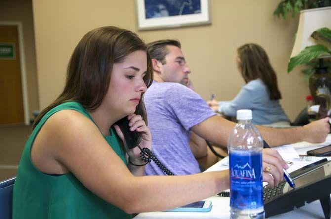 LSU finance senior Laura Johnson, student intern, (foreground) and LSU law student Colin Hotard (background) work together to make phone calls to potential voters of Jay Dardenne on Wednesday Sept. 9, 2015, at Jay Dardenne's campaign headquarters on Perkins Road.