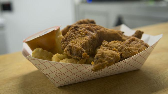 Located outside of Tigerland, foodtruck Sneaux Chicken sells fried food to passerbys.