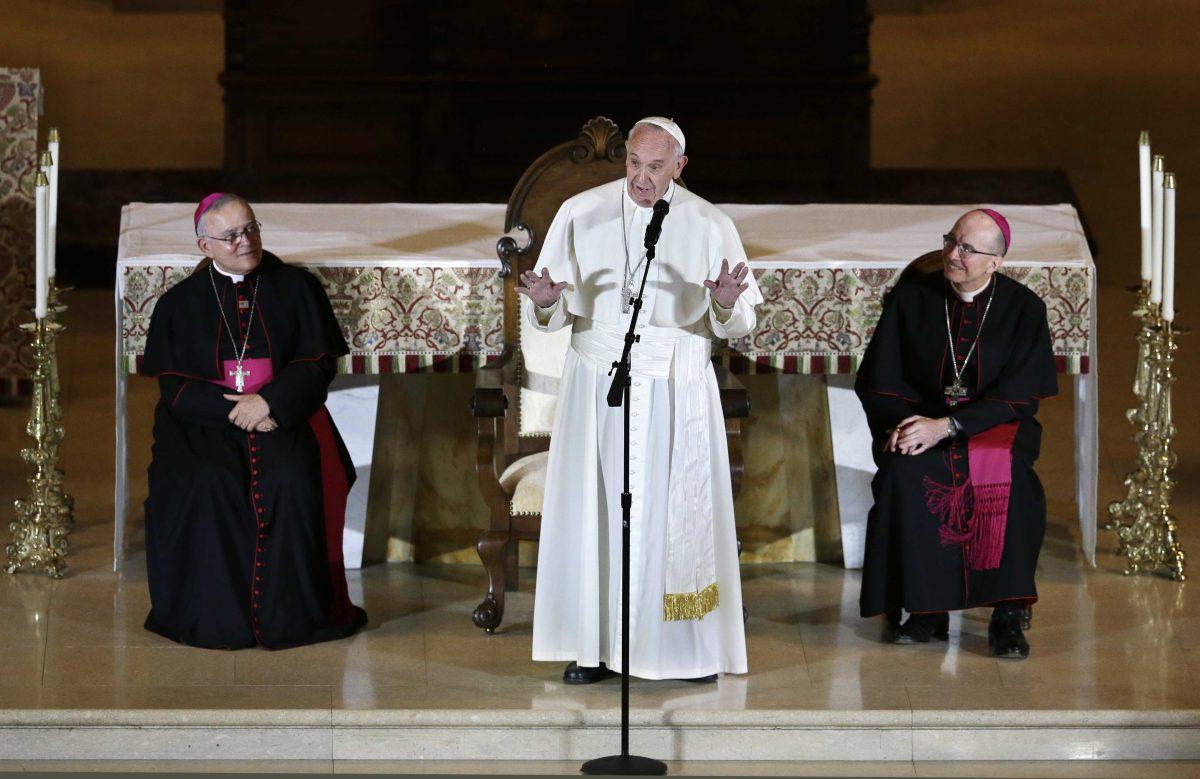 As Archbishop Charles Chaput, left, and Bishop Timothy Senior, right, listens as Pope Francis, addresses a gathering in Saint Martin's Chapel at St. Charles Borromeo Seminary Sunday, Sept. 27, 2015, in Wynnewood, Pa. (AP Photo/Mel Evans)