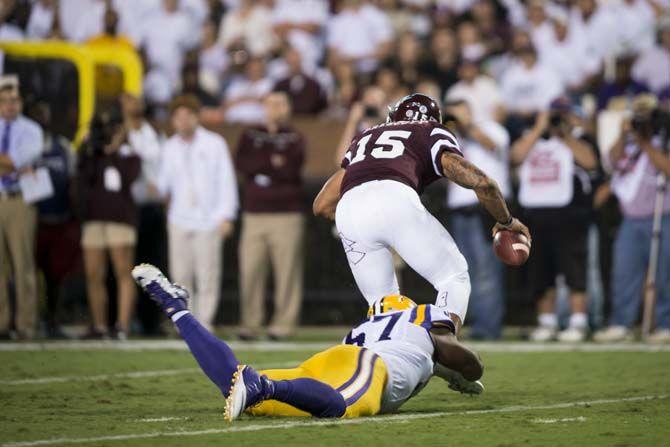 LSU Sophomore Defensive Tackle, Davon Godchaux (57), sacks Mississippi State Senior Quarterback, Dak Prescott (15), during the Tigers 21-19 victory over the Bulldogs on Saturday, at Davis Wade Stadium.