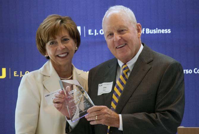 Jim Parr (right), who is an adjunct faculty member for the LSU Department of Marketing and Professional Sales Institue, and his wife Laura Parr (left) recieve an award from the E.J. Ourso College of Business on Wednesday Sept. 30, 2015, at the LSU Buisness Education Complex.