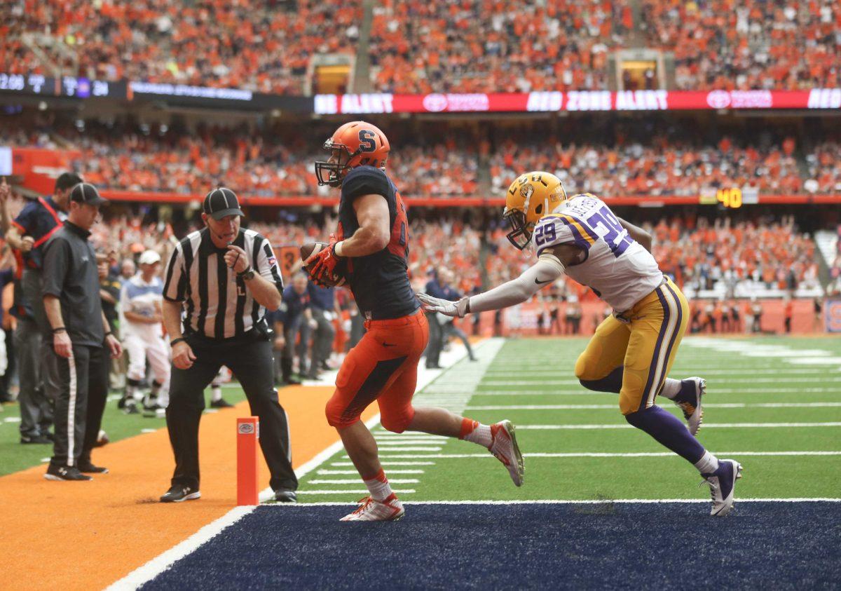 Syracuse running back Ben Lewis (84) makes a touchdown reception in front of LSU safety Rickey Jefferson (29) during the second half of an NCAA college football game on Saturday, Sept. 26, 2015, in Syracuse, N.Y. (AP Photo/Mike Groll)