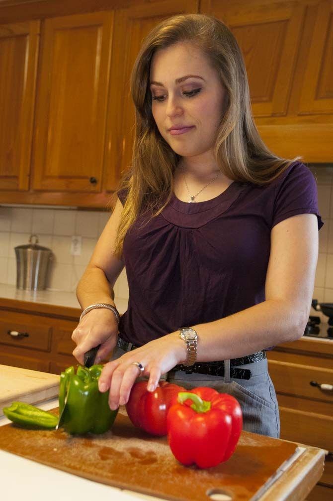 Kristen begins prepping fresh vegetables and some fruits for her next dish on Monday Sept. 21, 2015 at her parents house on highland.