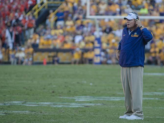 LSU football head coach Les Miles listens to the referee's call during the Tigers' 45-21 victory against Auburn on Saturday, Sept.19, 2015, in Tiger Stadium.