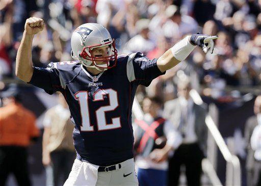 New England Patriots quarterback Tom Brady celebrates a touchdown run by running back Dion Lewis in the first half of an NFL football game Jacksonville Jaguars , Sunday, Sept. 27, 2015, in Foxborough, Mass. (AP Photo/Charles Krupa)