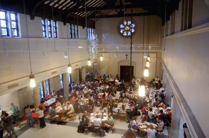 Students enjoy their free lunch probided by Our Lady of Mercy Catholic Church Thursday, September 4, 2014 in Christ the King Catholic Church.