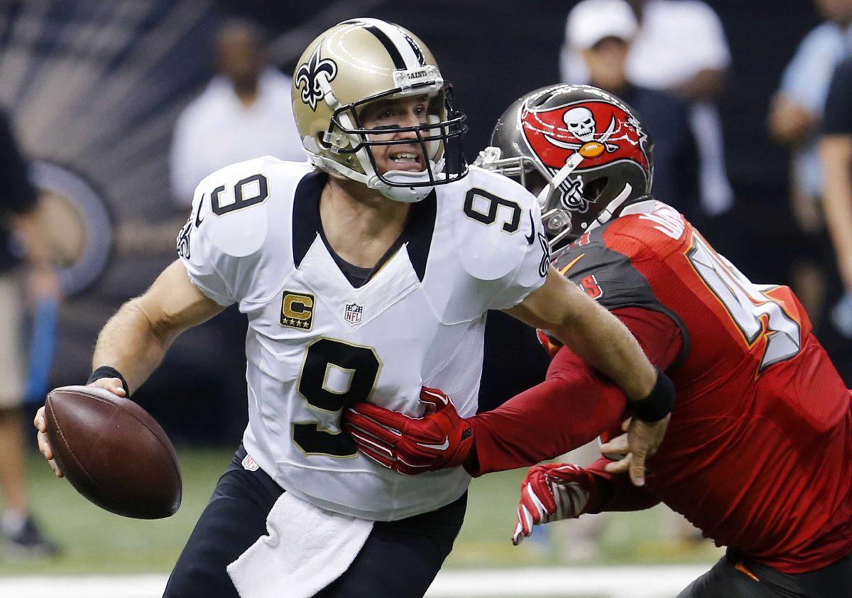 <p>FILE - In this Sept. 20, 2015 file photo, New Orleans Saints quarterback Drew Brees (9) scrambles under pressure from Tampa Bay Buccaneers defensive end George Johnson (94) in the first half of an NFL football game in New Orleans. The Saints have fallen to 0-2 because of a mistake-filled performance that drew boos from fans in the Superdome. Be it penalties, turnovers, blown assignments, special teams slip-ups or substitution problems, coach Sean Payton has a lot to address before a tough Week 3 contest at Carolina. (AP Photo/Bill Haber)</p>