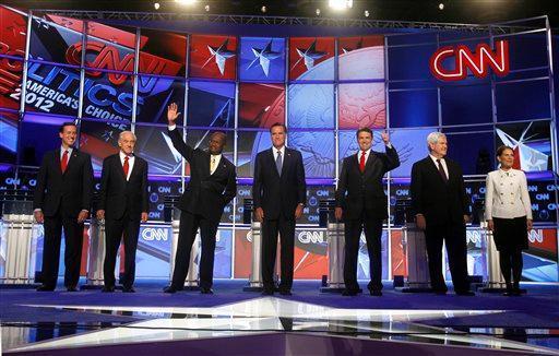 Republican presidential candidates, from left, former Pennsylvania Sen. Rick Santorum, Rep. Ron Paul, R-Texas, businessman Herman Cain, former Massachusetts Gov. Mitt Romney, Texas Gov. Rick Perry, former House Speaker Newt Gingrich and Rep. Michele Bachmann, R-Minn., pose for a photo before a Republican presidential debate Tuesday, Oct. 18, 2011, in Las Vegas.