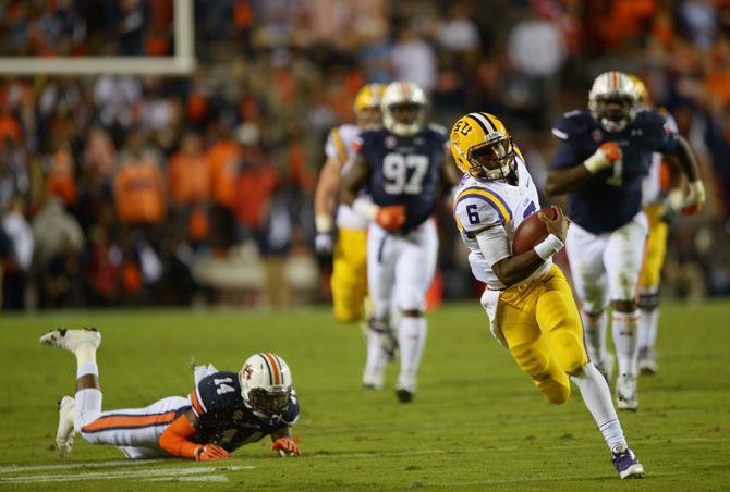 <p>LSU freshman quarterback Brandon Harris (6) runs the ball past Auburn freshman defensive back Stephen Roberts (14) Saturday, October 4, 2014 during the LSU Tigers' 41-7 loss against the Auburn Tigers in Jordan-Hare Stadium.</p>