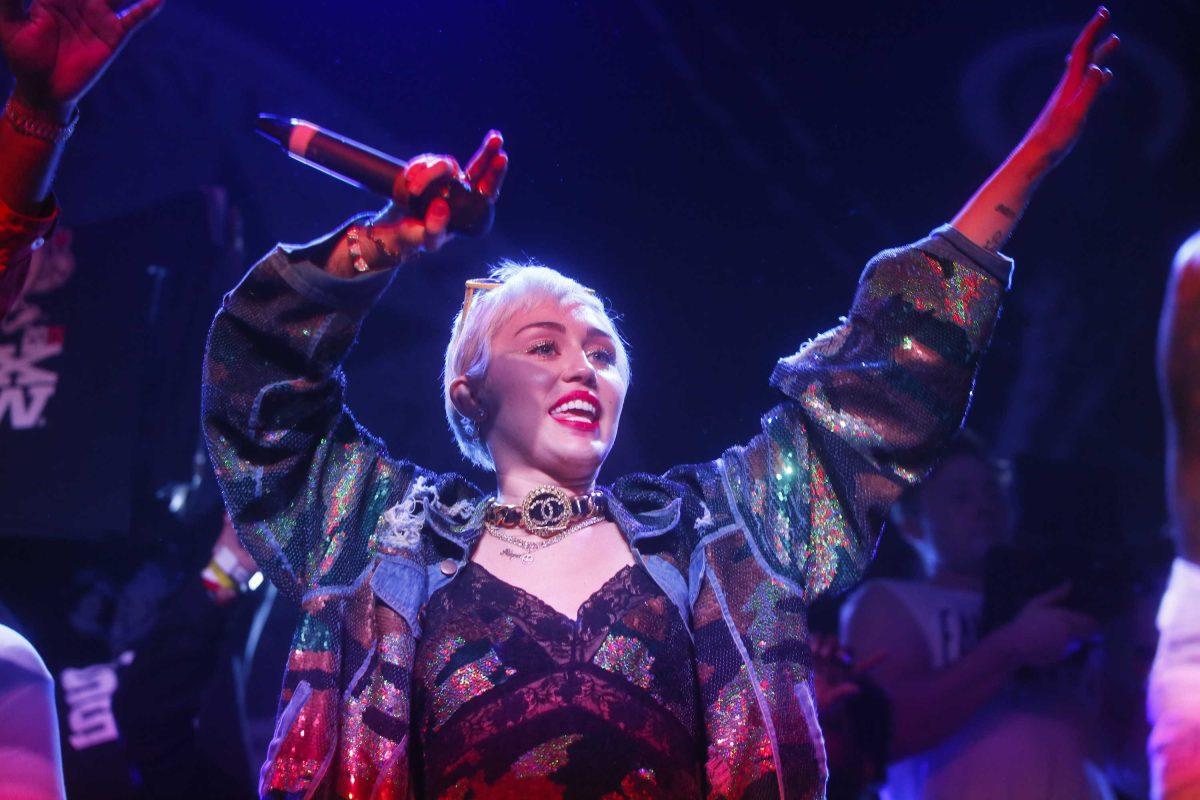 FILE - In this March 19, 2015 file photo, Miley Cyrus appears onstage for a Mike Will Made It performance at the Fader Fort Presented by Converse during the SXSW Music Festival in Austin, Texas. The 32nd annual MTV Video Music Awards hosted by Cyrus will broadcast live on MTV from 9-11 p.m. ET on Sunday, Aug. 30, at the Microsoft Theater in Los Angeles. Taylor Swift is also the top nominee, while Beyonce, Ed Sheeran, Nicki Minaj and Kendrick Lamar earned nominations for multiple awards. (Photo by Jack Plunkett/Invision/AP, File)