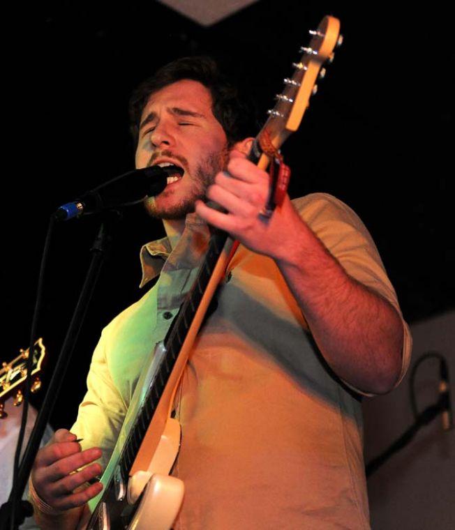 Economics sophomore and Stone Rabbits lead vocalist and guitarist Ben Burbrink sings into the microphone Saturday, Feb. 2, 2013 during a show at Shady's.