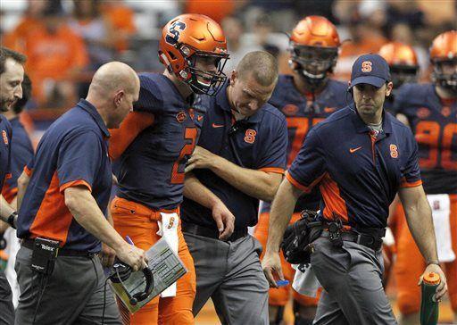 FILE - In this Saturday, Sept. 19, 2015, file photo, Syracuse’s Eric Dungey, second fromleft, is helped off the field after gettting injured in the second quarter of an NCAA college football game against Central Michigan in Syracuse. hafer has the Orange unbeaten after three games and now has to prepare for No. 8 LSU with an untested quarterback rotation that likely won't include freshman Eric Dungey. The team's new leader is not expected to play after suffering a helmet-to-helmet hit last game. (AP Photo/Nick Lisi, File)