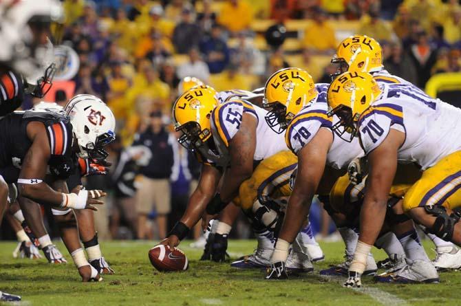 LSU senior center Elliott Porter (55) prepares to snap the ball in the line of scrimmage during the game on Saturday, September 21, 2013 during the Tigers' 35-21 victory against Auburn in Tiger Stadium.