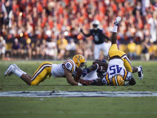 LSU senior linebacker Deion Jones (45) and junior defensive end Tashawn Bower (46) sack Auburn junior quarterback Jeremy Johnson (6) during the Tigers' 45-21 victory against Auburn on Saturday, Sept.19, 2015, in Tiger Stadium.