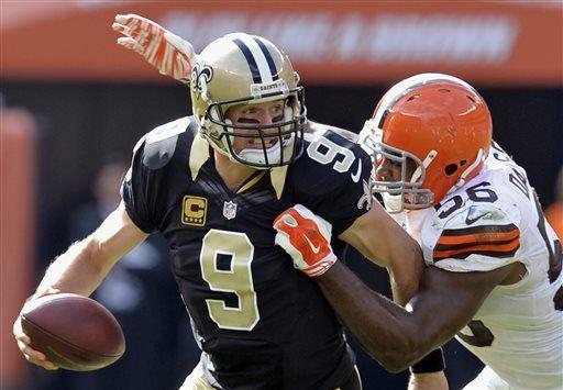 Cleveland Browns linebacker Karlos Dansby (56) sacks New Orleans Saints quarterback Drew Brees in the fourth quarter of an NFL football game Sunday, Sept. 14, 2014, in Cleveland. (AP Photo/David Richard)