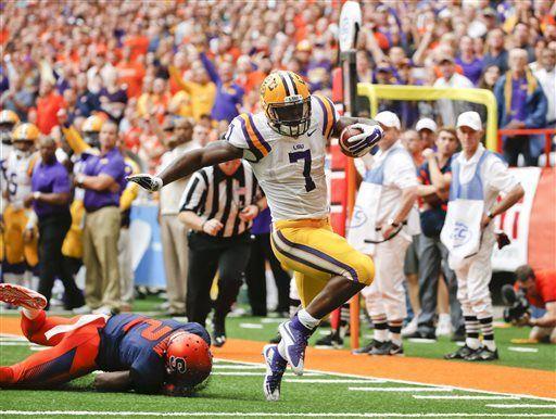 LSU running back Leonard Fournette (7) gets past Syracuse cornerback Wayne Morgan (2) for a touchdown in the first half of an NCAA college football game, Saturday, Sept. 26, 2015, in Syracuse, N.Y. Leonard Fournette ran for a career-high 244 yards and two touchdowns in their 34-24 win. (AP Photo/Mike Groll)