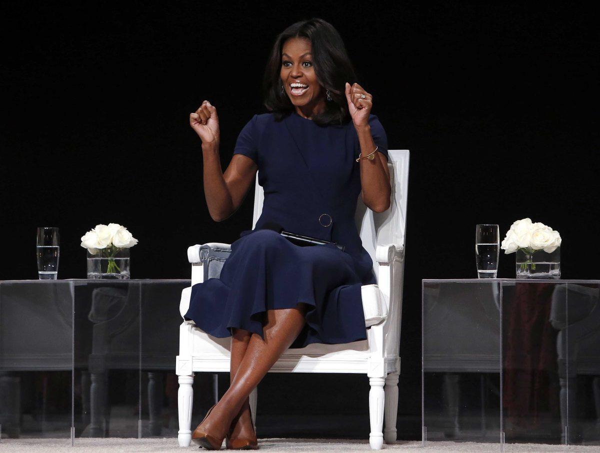 First lady Michelle Obama reacts to an ovation from the audience as she takes the stage for a panel discussion entitled "The Power of an Educated Girl" at the Apollo Theater, Tuesday, Sept. 29, 2015, in New York. (AP Photo/Jason DeCrow)