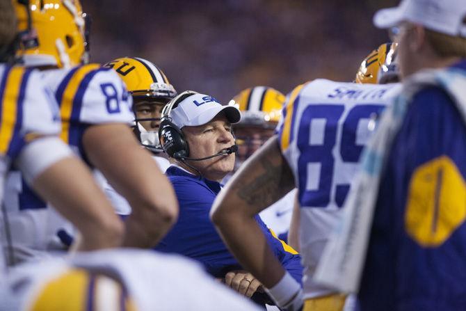 LSU head coach Les Miles huddles with members of the team on Saturday, Oct. 17, 2015, during the Tigers' 35-28 victory against Florida in Tiger Stadium.