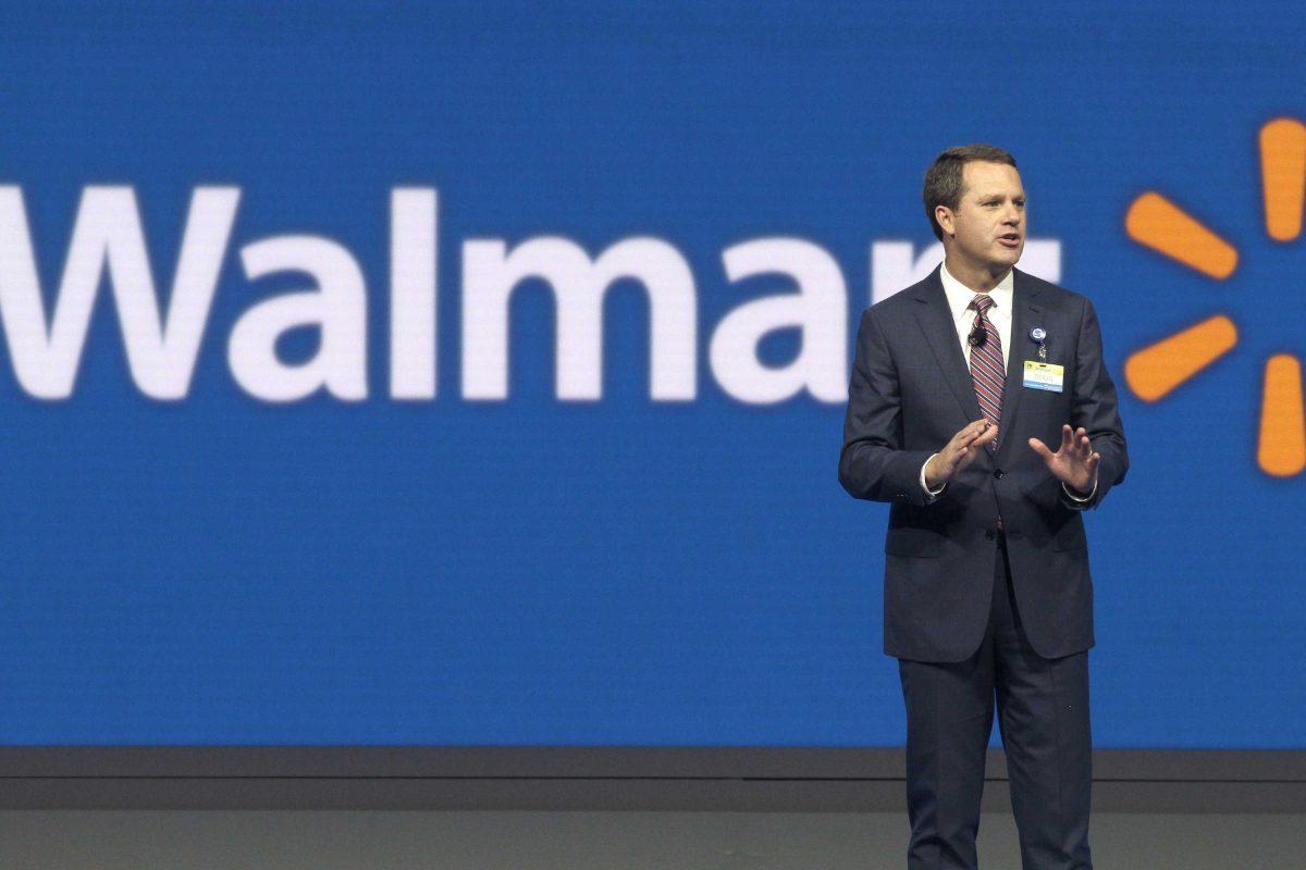 In this Friday, June 5, 2015 photo, Wal-Mart Chief Executive Officer Doug McMillon speaks at the company's shareholder meeting in Fayetteville, Ark. On Friday, Oct. 2, 2015, Wal-Mart laid off 450 workers at its headquarters in Bentonville, Ark., as the world's largest retailer attempts to become more nimble to compete with the likes of Amazon.com. (AP Photo/Danny Johnston)