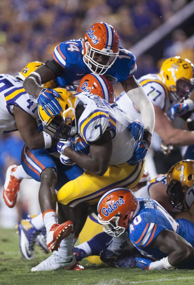 LSU sophomore running back Leonard Fournette (7) is tackled by several members of Florida's defense on Saturday, Oct. 17, 2015, during the Tigers' 35-28 victory against the Gators in Tiger Stadium.