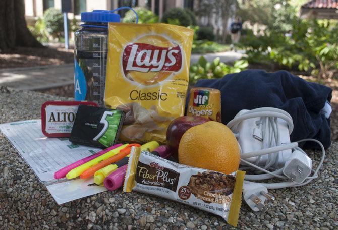 Backpack essentials for studying in Middleton include a variety of things including a granola bar, highlighters, chewing gum and a computer charger.