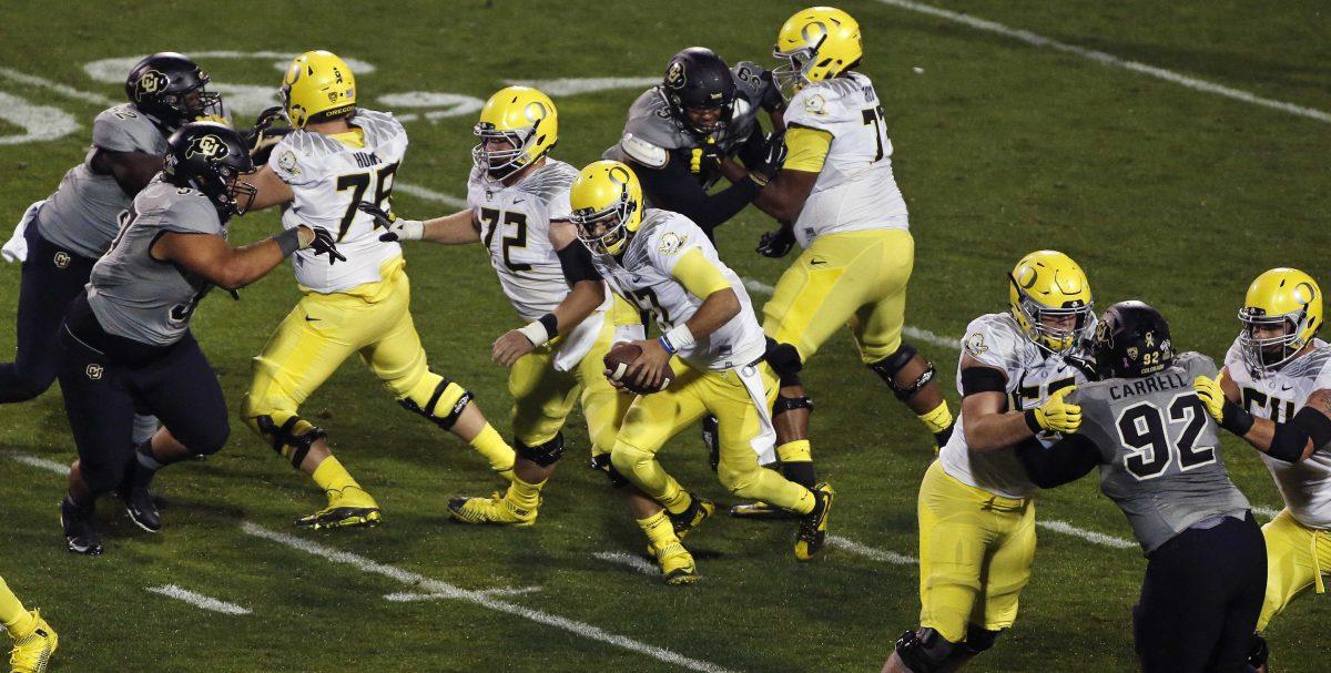 Oregon quarterback Jeff Lockie (17) runs through an opening in Colorado's defense in the first half of an NCAA college football game in Boulder, Colo., Saturday, Oct. 3, 2015. (AP Photo/Brennan Linsley)