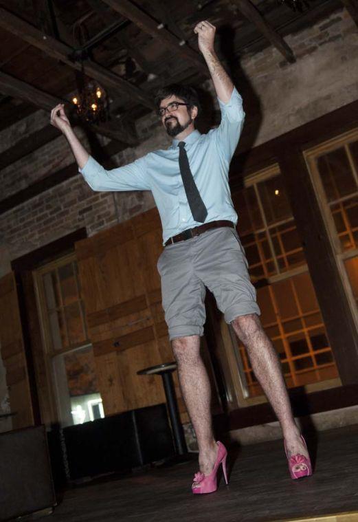 A man in heels prepares to strut down the runway at the Hunks in Heels event Thursday, September 19, 2013 at The Office Bar in Downtown Baton Rouge.