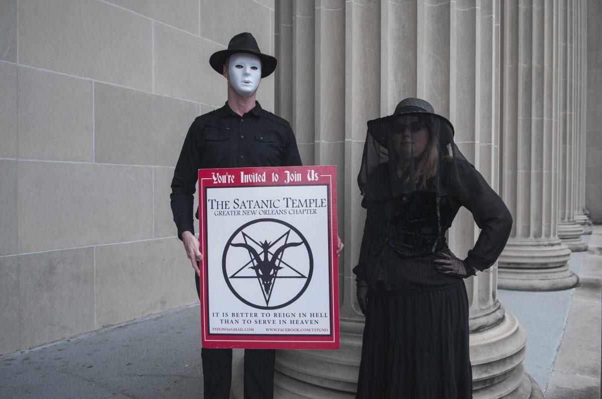 Members of The Satanic Temple of the Greater New Orleans Chapter wear masks and veils to hide their identity on Sunday, October 4, in front of the Orleans Parish Criminal Justice Court.