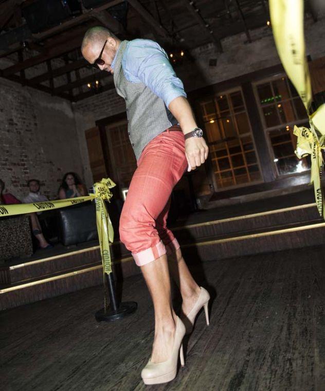 Eric Dexter struts down the runway in high heels Thursday, September 19, 2013 at the Hunks in Heels event at The Office Bar in Downtown Baton Rouge.