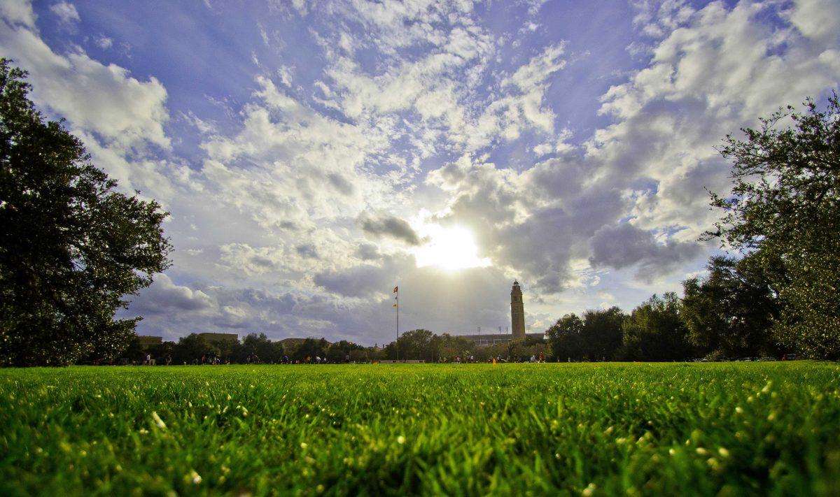 The sun begins its decent toward the horizon as people play ball on the Parade Grounds.