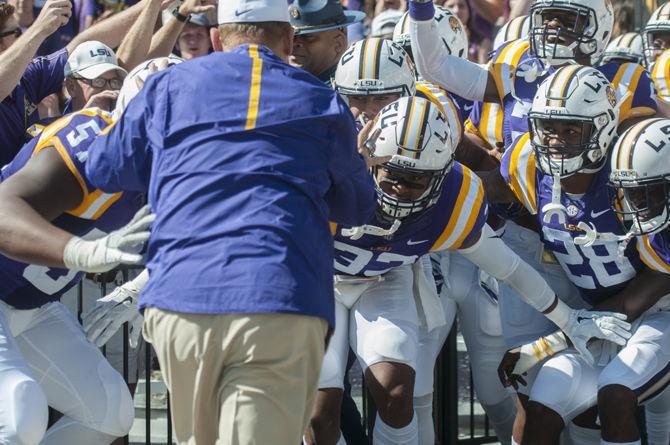 LSU head coach Les Miles holds the team back when entering the field during the Tigers&#8217; 45-24 victory against the University of South Carolina on Saturday, Oct. 10, 2015 in Tiger Stadium.