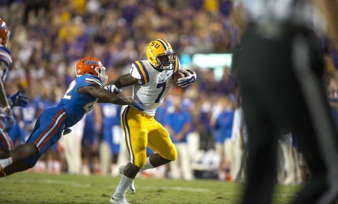 LSU sophomore running back Leonard Fournette (7) pushes back Florida junior defensive back Keanu Neal (42) as he runs toward the Florida in-zone during the LSU 35-28 victory against the Gators on Saturday Oct. 17, 2015, in Tiger Stadium on LSU's campus.