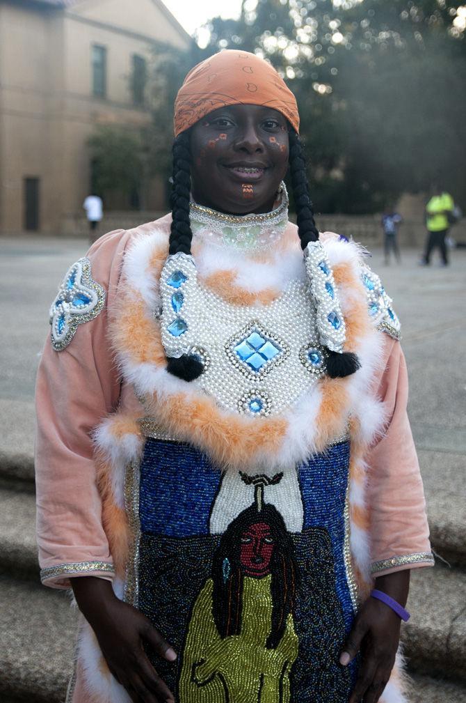 Tonya Johnson dons traditional clothes to show support for the fight against domestic violence during Take Back The Night on Oct. 11, 2015, in front of the Memorial Tower.