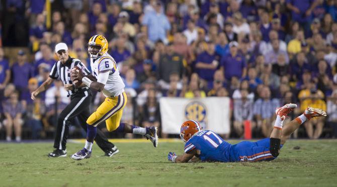 LSU sophomore quarterback Brandon Harris (6) dodges an attempted tackle by Florida rush linebacker Jordan Sherit (17) on Saturday, Oct. 17, 2015, during the Tigers' 35-28 victory against the Gators in Tiger Stadium.