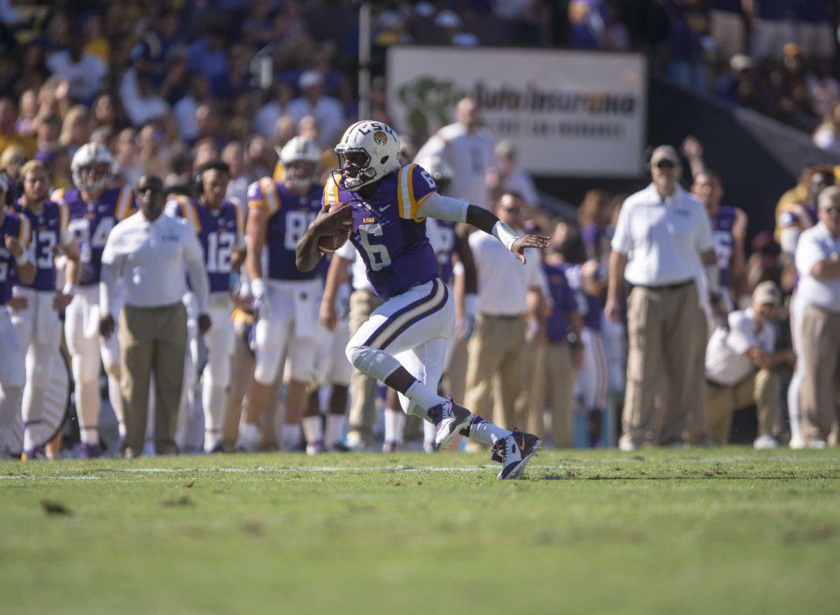 <p>LSU sophomore quarterback Brandon Harris (6) runs the ball during the Tigers' 45-24 victory against the University of South Carolina on Saturday, Oct. 10, 2015, in Tiger Stadium.</p>