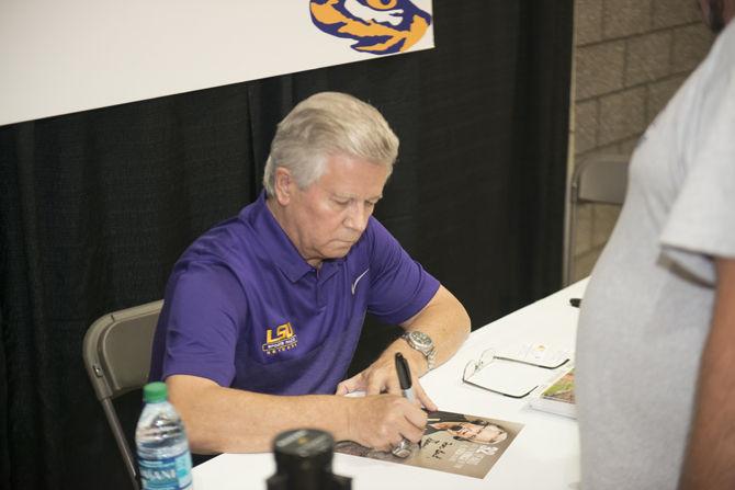 LSU radio broadcaster Jim Hawthorne signs autographs during fan day on Sunday, Aug. 16, 2015 at the Carl Maddox Field House.