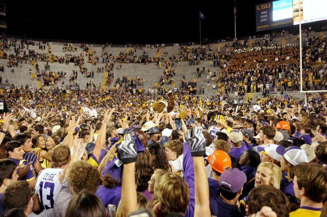 LSU football players and students rush the field and celebrate the Tigers' 10-7 victory against Ole Miss Saturday, October 25, 2014 in LSU Tiger Stadium.