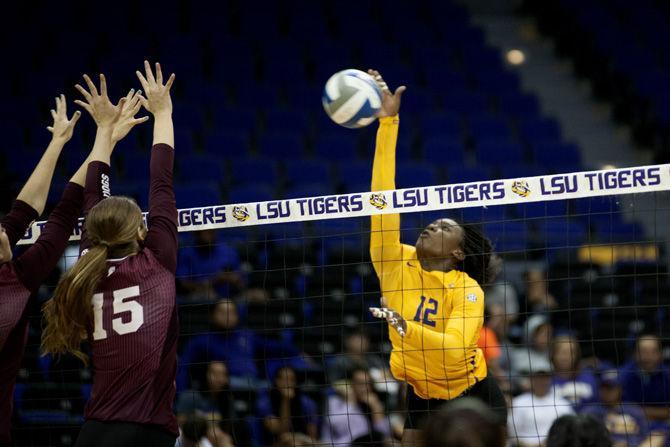 LSU sophomore Gina Tillis (12) performs a high-velocity spike during the Tigers' 3-0 victory against Mississippi State University on Oct. 16, 2015, in the PMAC.